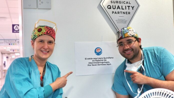 Foto: Doctores señalando un cartel que indica la atención pediátrica en español - Seattle Children's