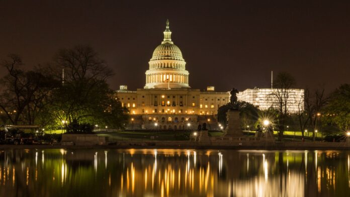 The US Capitol White House near a Lake at Night The US Capitol White House near a Lake at Night