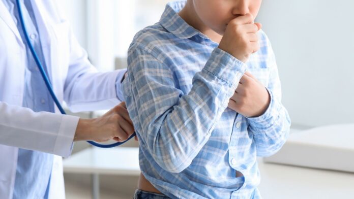 Ill Coughing Little Boy Visiting Doctor in Clinic