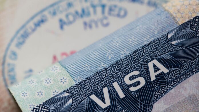 Close up of a Visa Spamp in a Passport. Immigration and Emigrati Close up of a Visa Spamp in a Passport. Immigration and Emigrati