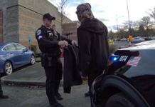 Robo en Target de Redmond termina con arresto y apoyo humanitario Foto: Agentes de Redmond le entregan a un hombre en situación de calle una chamarra - Cortesía de la policía de Redmond