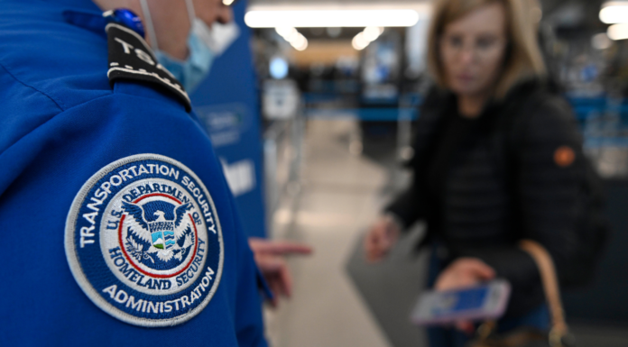 Trump firma orden para pagar a la TSA tras colapso del financiamiento en el Congreso Agente de TSA revisa el pase de abordar y la identificación de una pasajera en el Aeropuerto O'Hare, en Chicago, el 26 de marzo de 2026. (Foto AP/Paul Beaty)