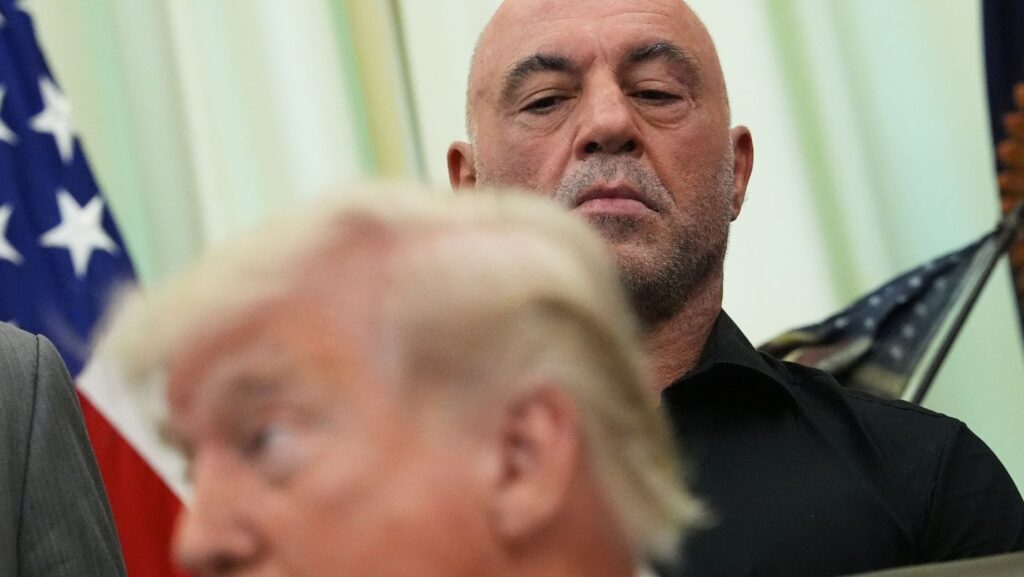 El podcaster Joe Rogan escucha a Trump hablar en el Despacho Oval de la Casa Blanca, el sábado 18 de abrilde 2026. (Foto de AP/Julia Demaree Nikhinson)

