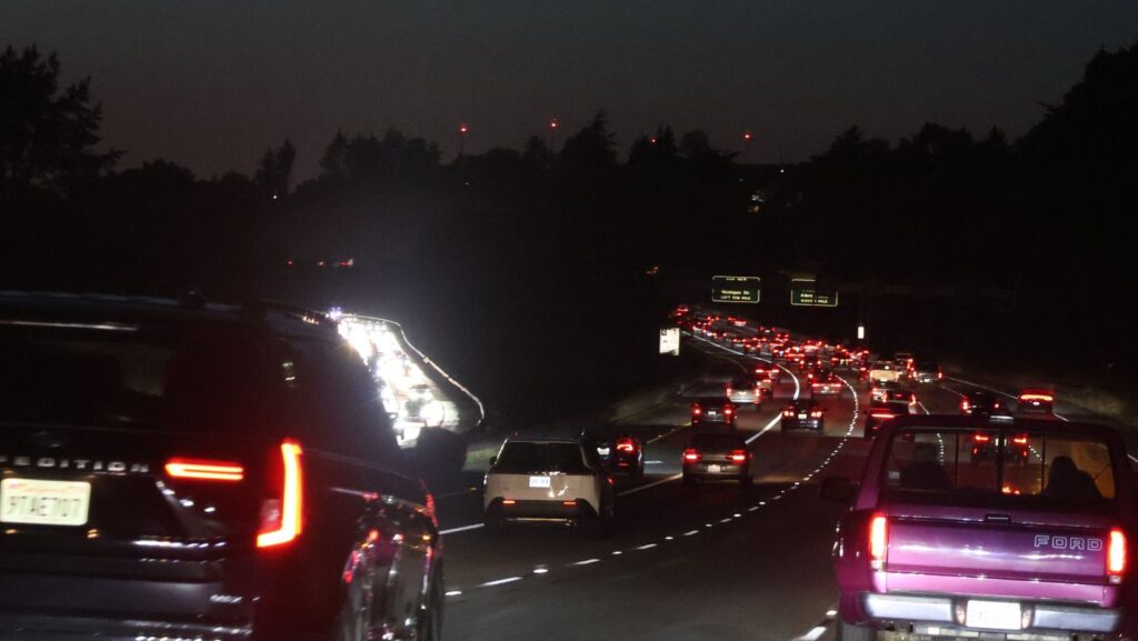 Tráfico intenso durante la noche en una autopista del área de Seattle, con largas filas de vehículos circulando en ambas direcciones.